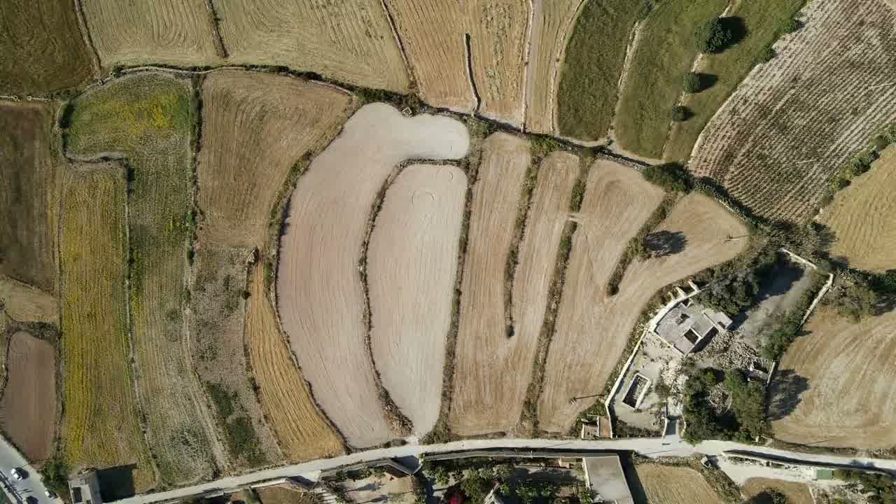 Drone flying a straight survey line over patchwork farmland.